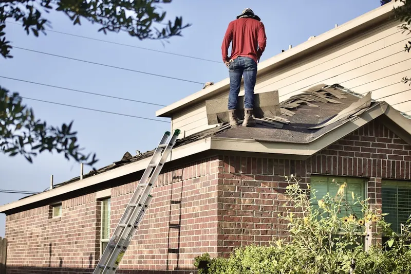 Professional roofer working on a residential roof in Centennial Homestead